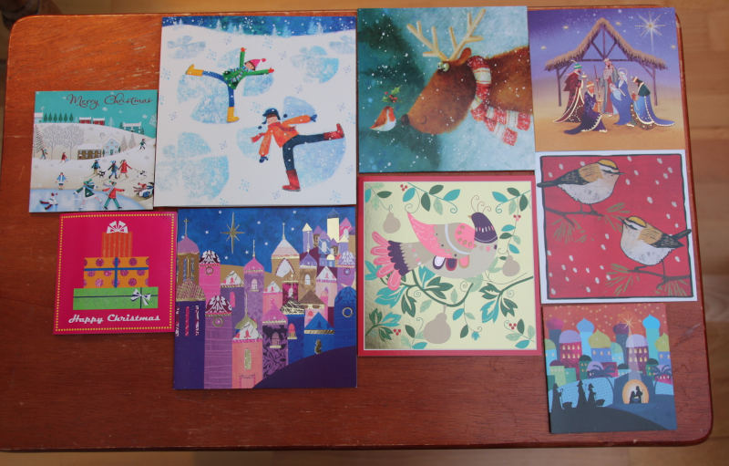 9 square christmas cards covering table area