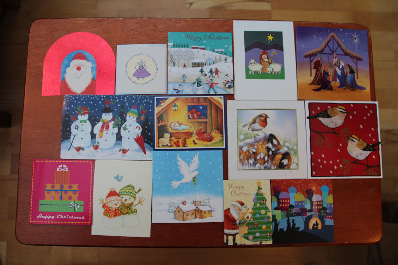 14 small christmas cards covering table area