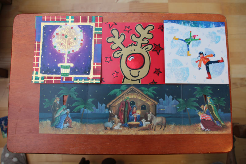 4 big christmas cards covering table area